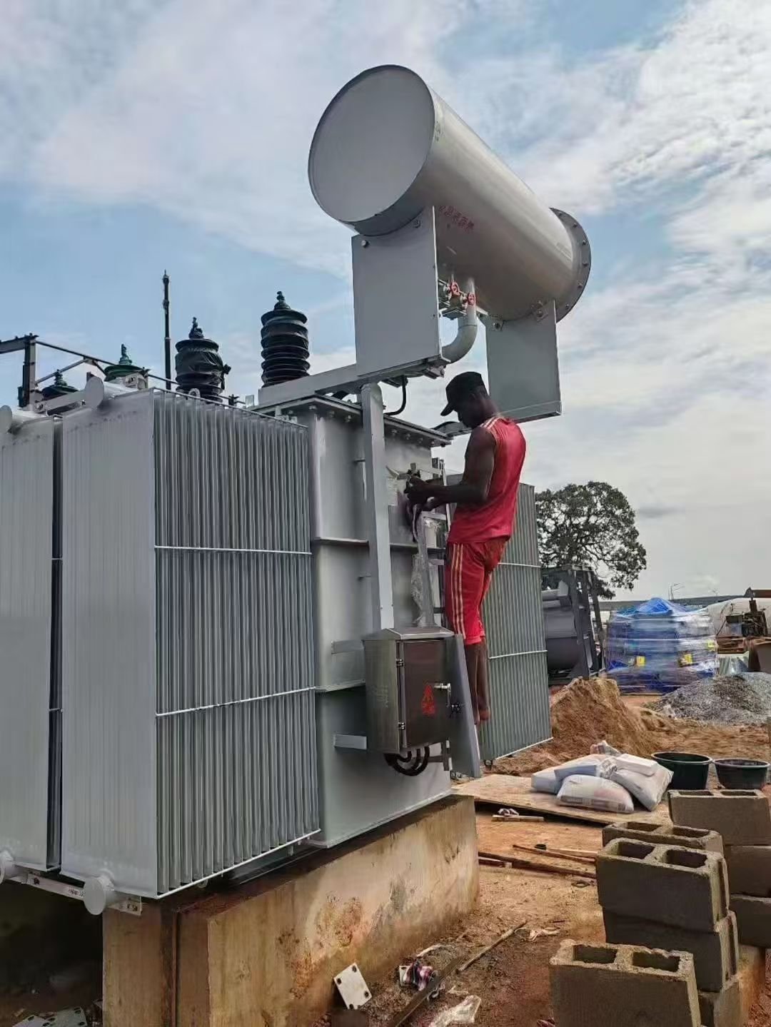 Technicians working on an oil transformer installation